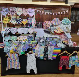 a table with clothes and clothes on it all handcrafted by distinctly individual