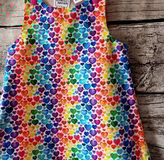 a colourful rainbow heart print dress for children