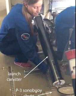 K. Ryan preparing to launch folded Coyote onboard NOAA P-3 plane.