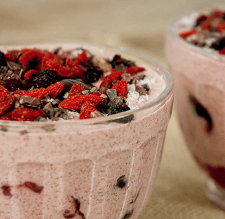 two cups of fruit and chocolate pudding in a glass