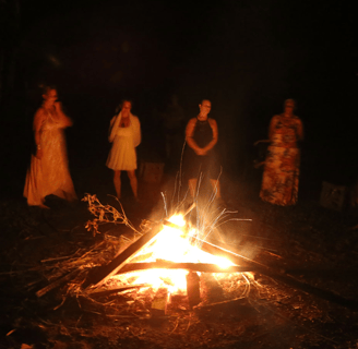 a bunch of people around a fire