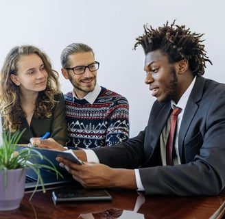 An agent explaining insurance benefits to a couple.