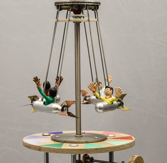 Model carousel with carved figures riding in tiny gas cartridges that will swing out when spun