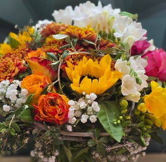 a bouquet of flowers in a vase on a table