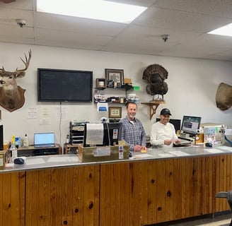 Paul and Gilbert working at front counter