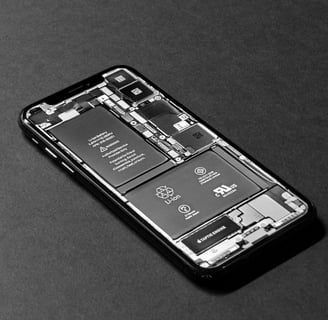 Cell phone with back panel removed, revealing battery and internal components for professional batte