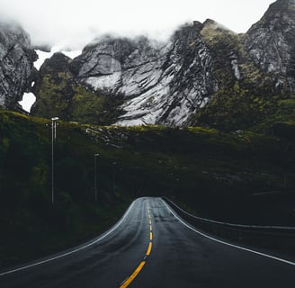 a road with a mountain in the background