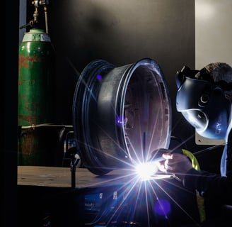 a man in a gas mask welding a pipe