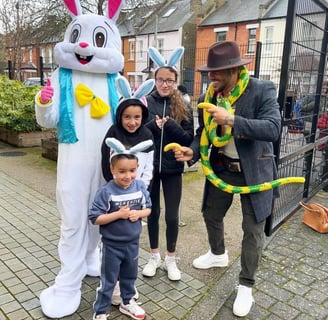 a person in a bunny suit and children wearing a bunny ears