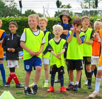 a group of young children football players standing in a field