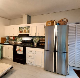 a kitchen with a refrigerator, refrigerator, and refrigerator freezer