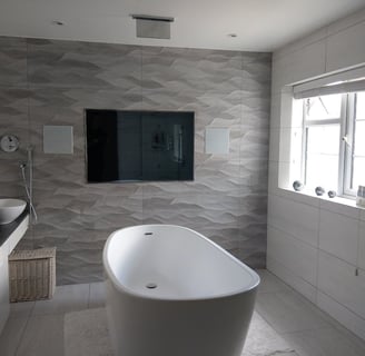 65" Auquavision, waterproof TV mounted onto a wall in a bathroom