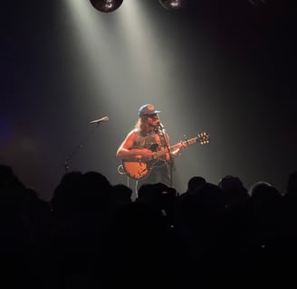a man playing guitar in a concert