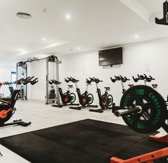 a gym room with a bunch of exercise equipment
