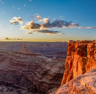 a person standing on a cliff overlooking a canyon