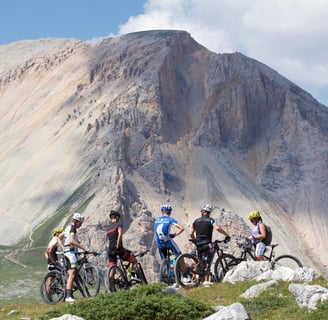 a group of people riding bikes on a mountain