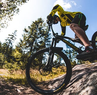 a person riding a bike on a rock wall