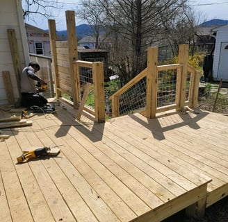 construction worker installing fencing for a newly constructed porch for a home in Hickory, NC