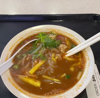 Laksa, a noodle dish in a fish based broth with cucumber and pineapple