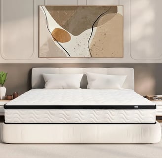 a bed with a white bed and a painting on the wall