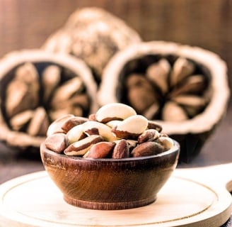 nuts nuts and nuts in a bowl on a wooden table