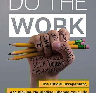 a person holding pencils and writing on a book