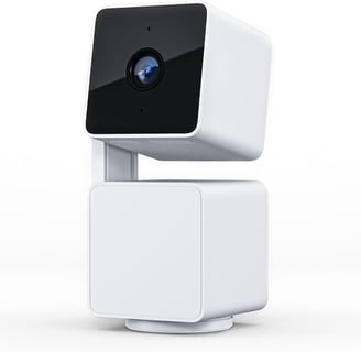 a camera mounted to a white cube with a camera