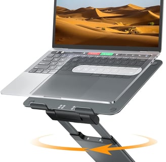 a laptop computer sitting on a stand with a laptop
