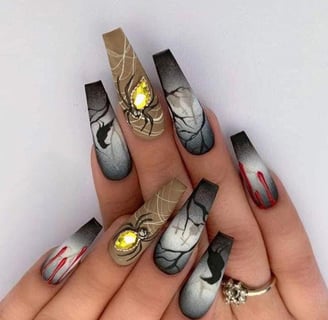 "Stylish press-on nails with Halloween-themed designs, perfect for a spooky look."