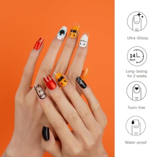 a woman's hands with a halloween nail - art manicures
