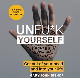 a person's hand holding up a hand with the words unfuk yourself