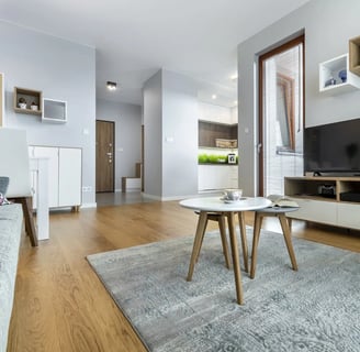a living room with a couch, chair, and television