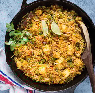 A fragrant, ghee-kissed basmati rice dish with golden-fried paneer, vibrant veggies, and whole spice