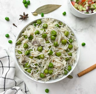 A fragrant rice dish bursting with sweet green peas, whole spices, and a touch of ghee.