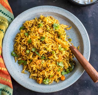 Veg Tawa Pulao - spicy, street-style rice tossed on a tawa with masalas, crunchy veggies, & butter.