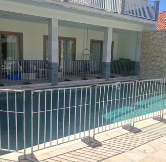 a pool with a fenced in area with a grill