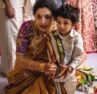 a woman and a young boy are sitting on a table