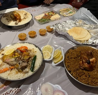 a table with a variety of Arab food in Jeddah, Saudi Arabia