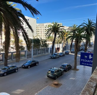 a street scene with cars parked on the side of the road