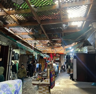 a man standing in a market place with a lot of people