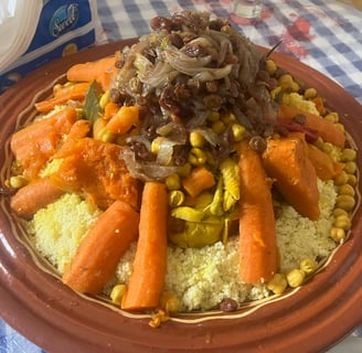 a plate of couscous with carrots and vegetables