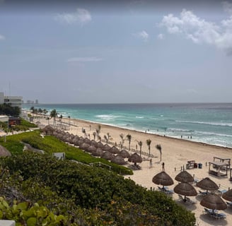 a beach with umbrellas and umbrellas on the beach
