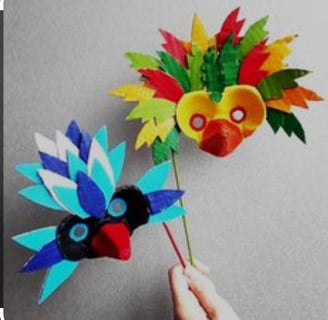 a person holding a paper flower with a bird on it