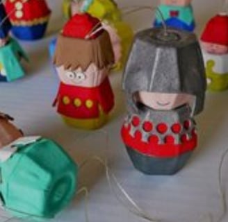 a group of paper mache dolls with a paper doll