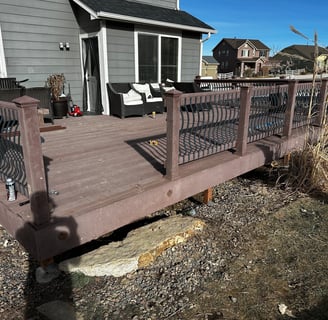 a deck with a bench and chairs