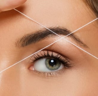 a woman with a thread threading on her forehead