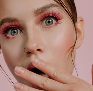 a woman with a pink eye makeup and a pink lip