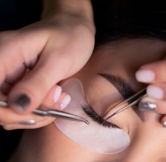 a woman is doing a makeup job on her eyebrows