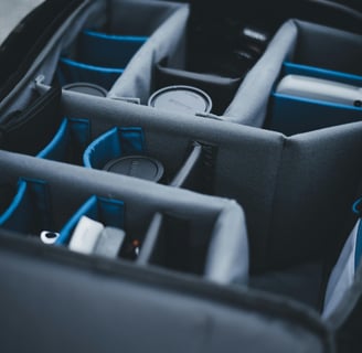 a bag of electronics and a camera in a bag