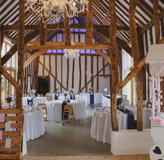 Beautiful barn converted wedding venue, with tables laid out ready for wedding breakfast